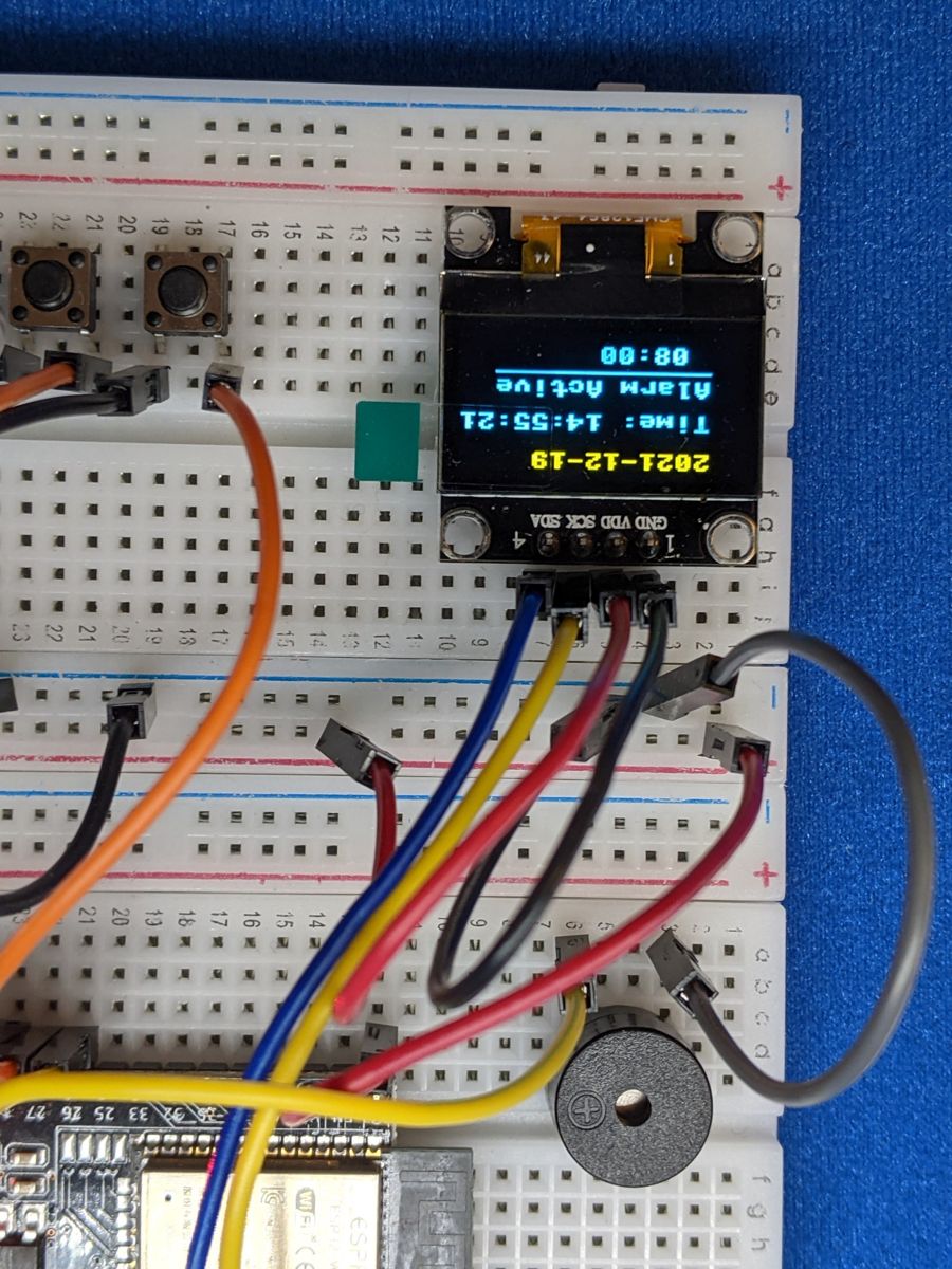 Alarm clock showing the time on an OLED screen