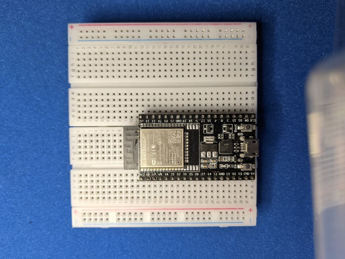 An ESP32 straddling two breadboards