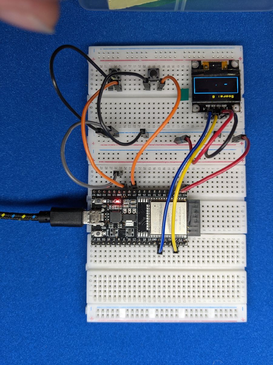 Snake game running on an OLED screen
